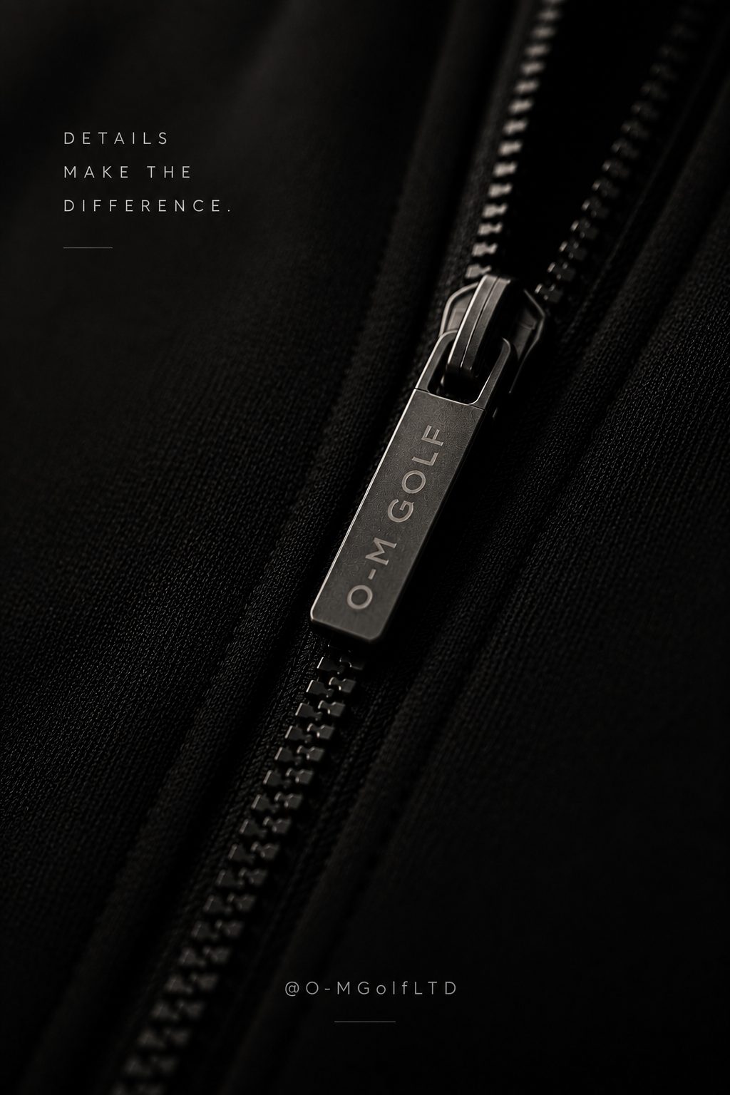 Close-up of the engraved zip and O-M Golf emblem